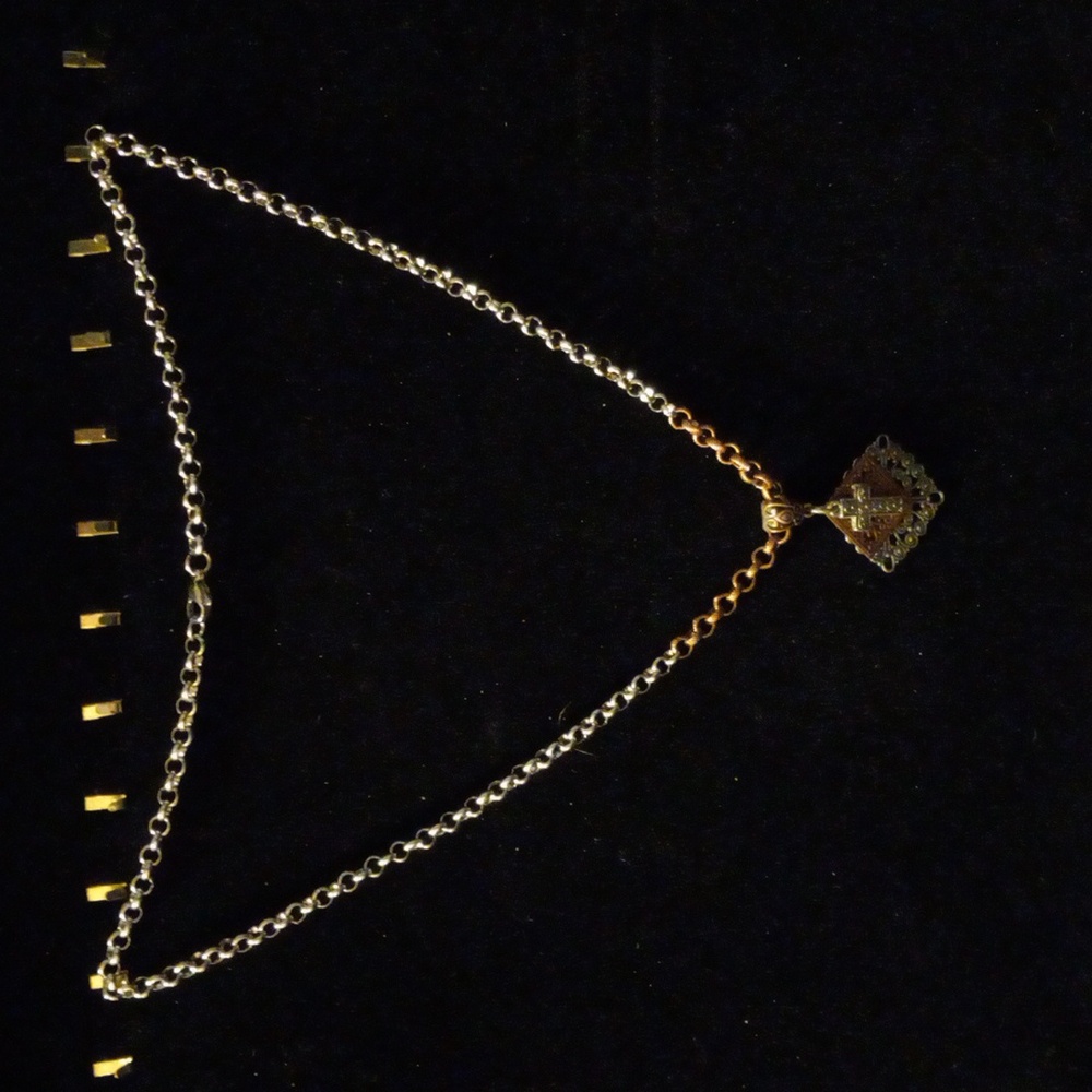 22" silver and copper tone circle link chain with a cross pendant also 2 toned.
